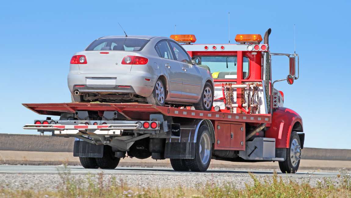 A tow truck driver repossessing a vehicle from a customer who defaulted on a title loan.